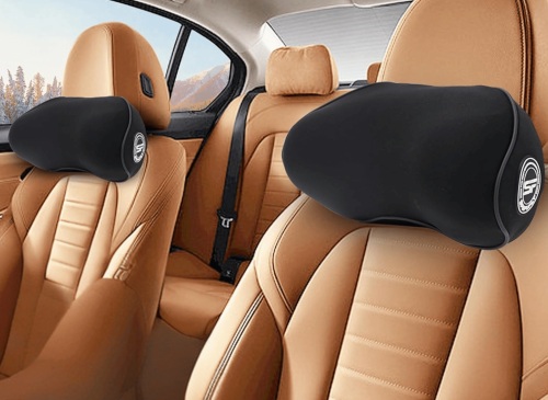"Black ergonomic memory foam car neck pillows installed on the front and rear headrests of a tan leather car interior"