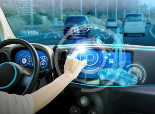 Concept image of smart connected vehicle cockpit, with a driver touching a futuristic holographic interactive interface that integrates road obstacle recognition, real-time speed display, driver physical condition monitoring and vehicle status data.