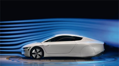 "White streamlined concept sports car undergoing aerodynamic testing in a wind tunnel with visualized blue airflow lines"